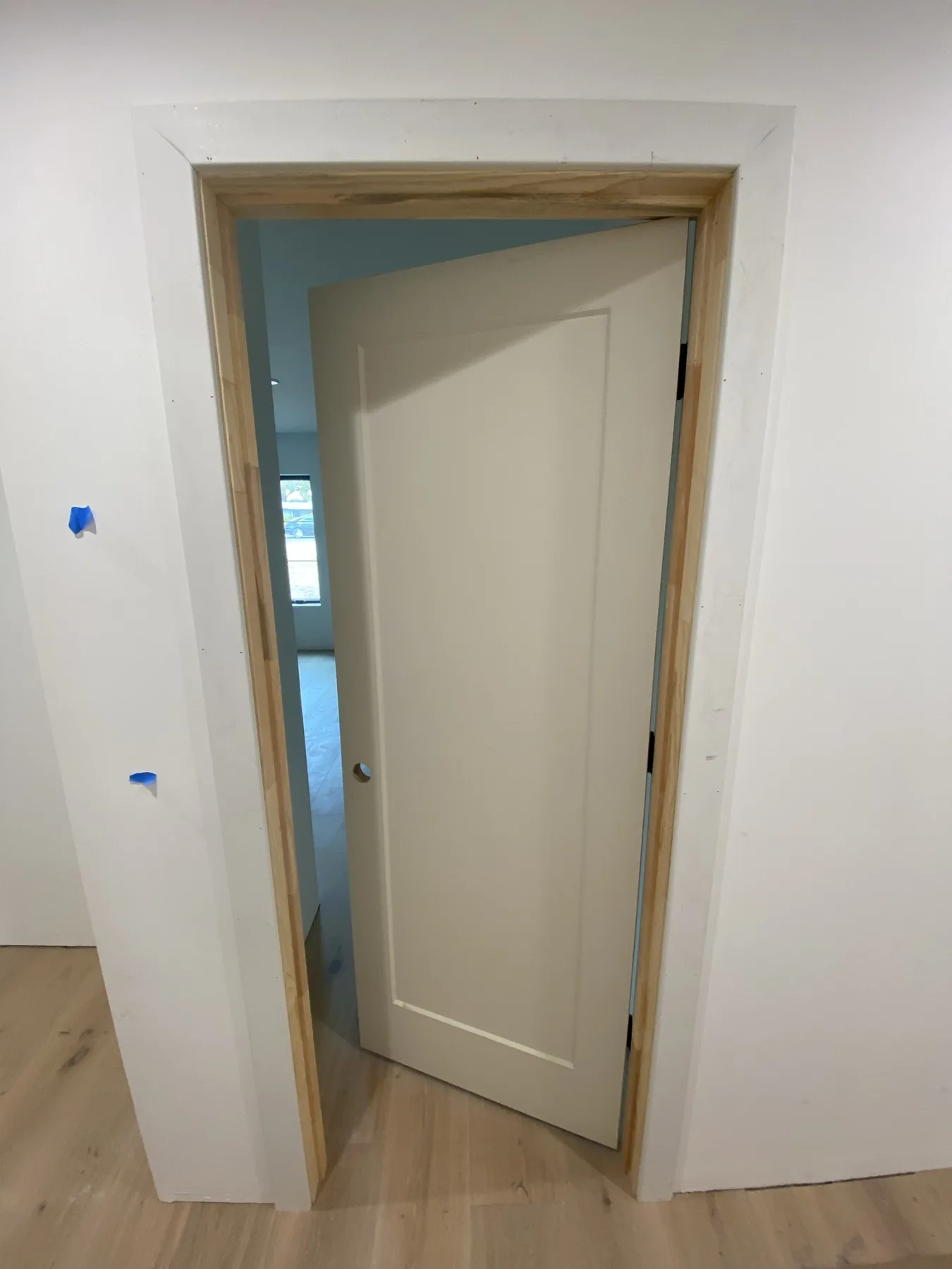 Unpainted single-panel door with open swing at E Calle Ventura