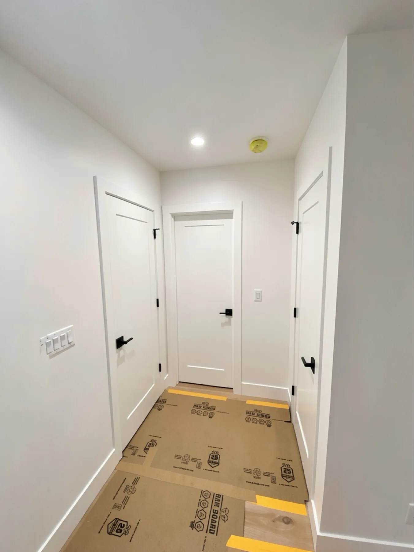 Finished hallway with multiple single-panel door installations at E Calle Ventura