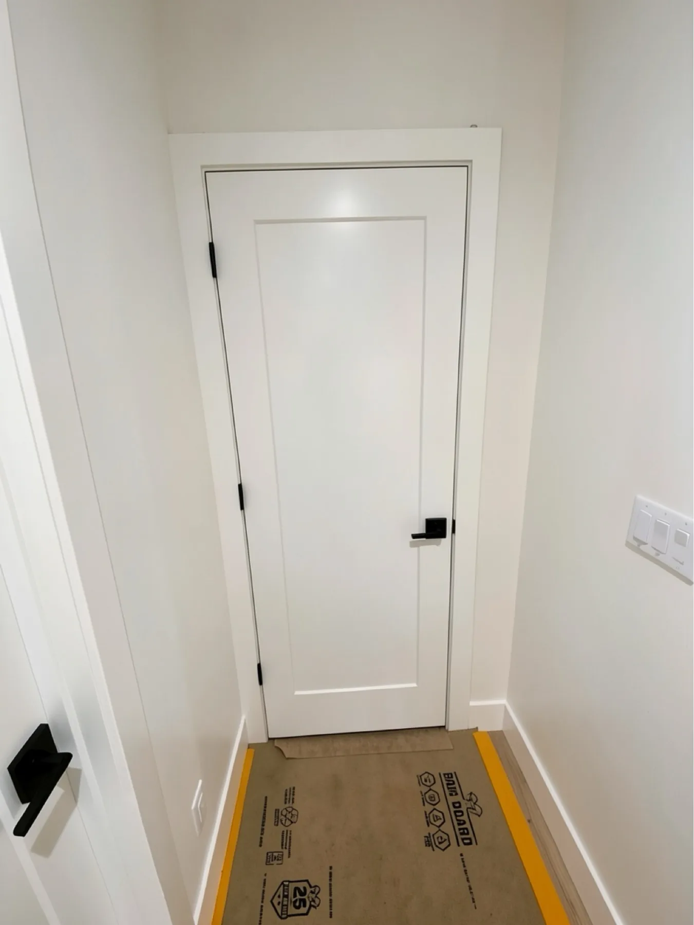 Finished interior door installation with floor protection at E Calle Ventura