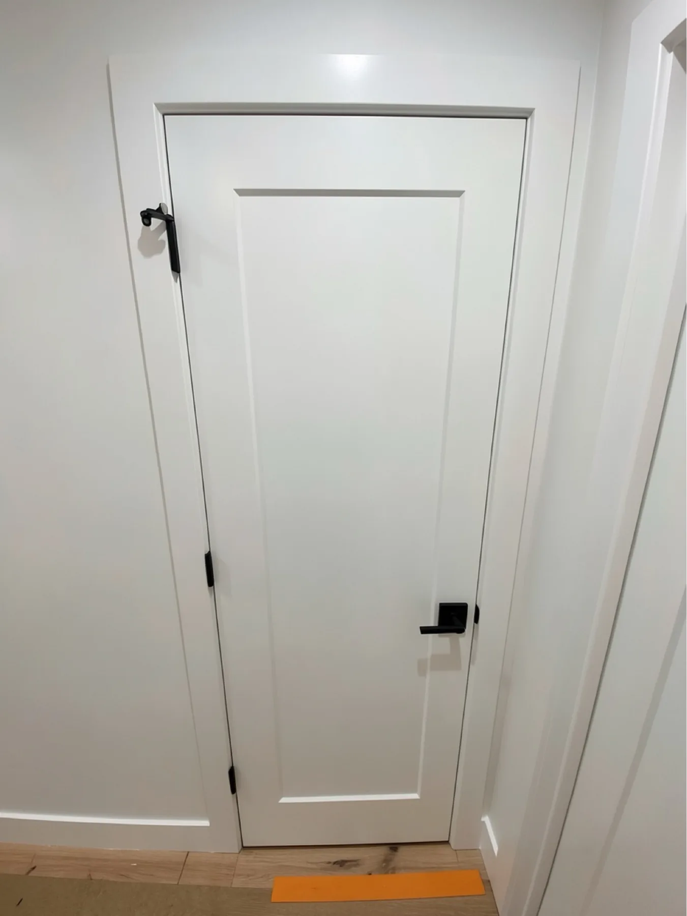 Finished single-panel door and hardware close view at E Calle Ventura
