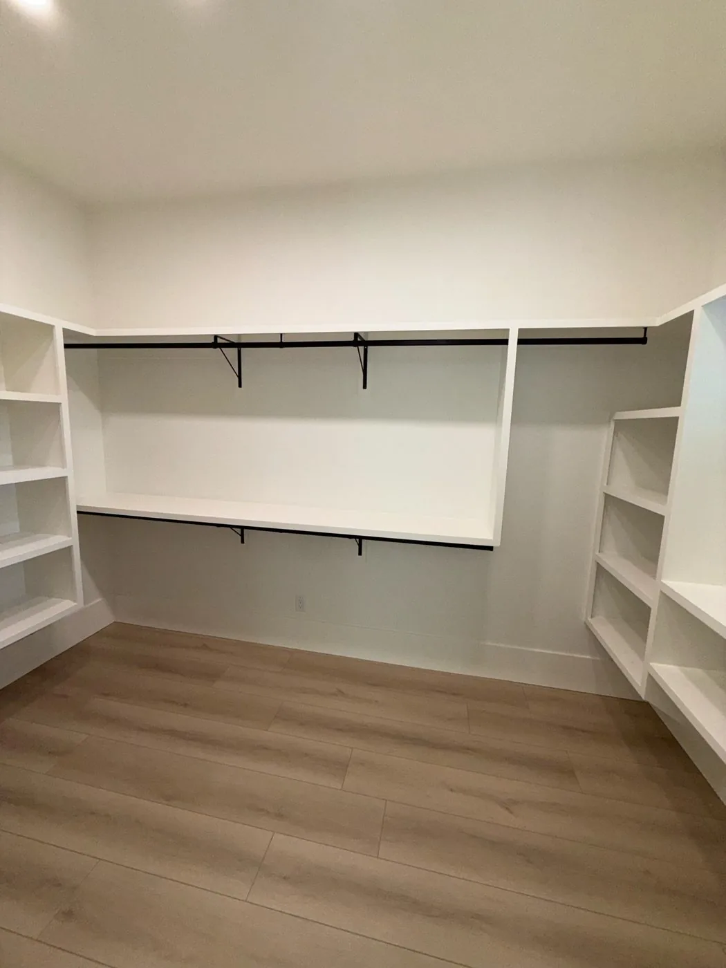 Closet shelving, closet rod, and 9 1/4 inch flat base installation at The El Sendero Project