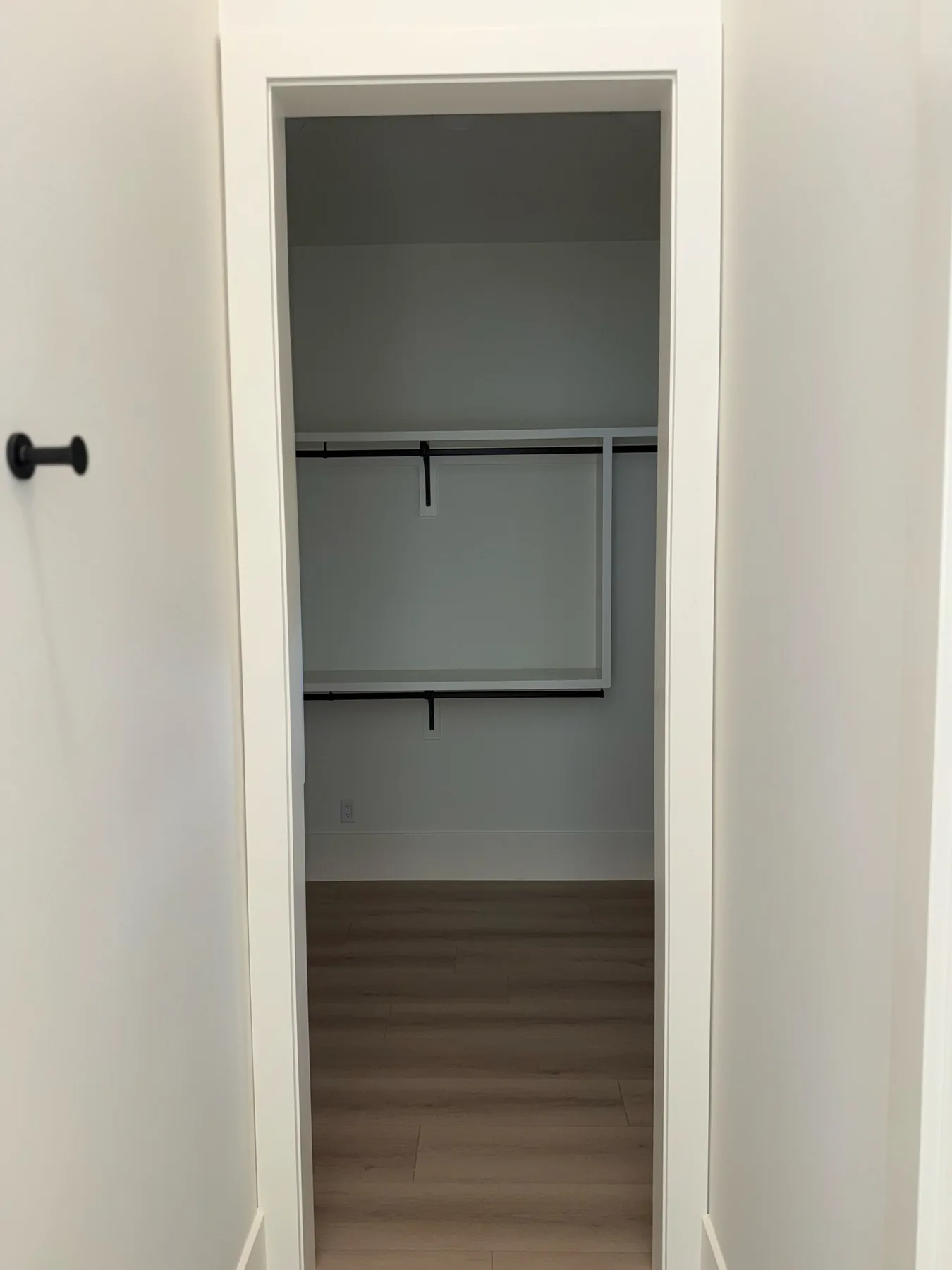 Closet doorway with casing, hardware, closet shelving, and baseboard at The El Sendero Project