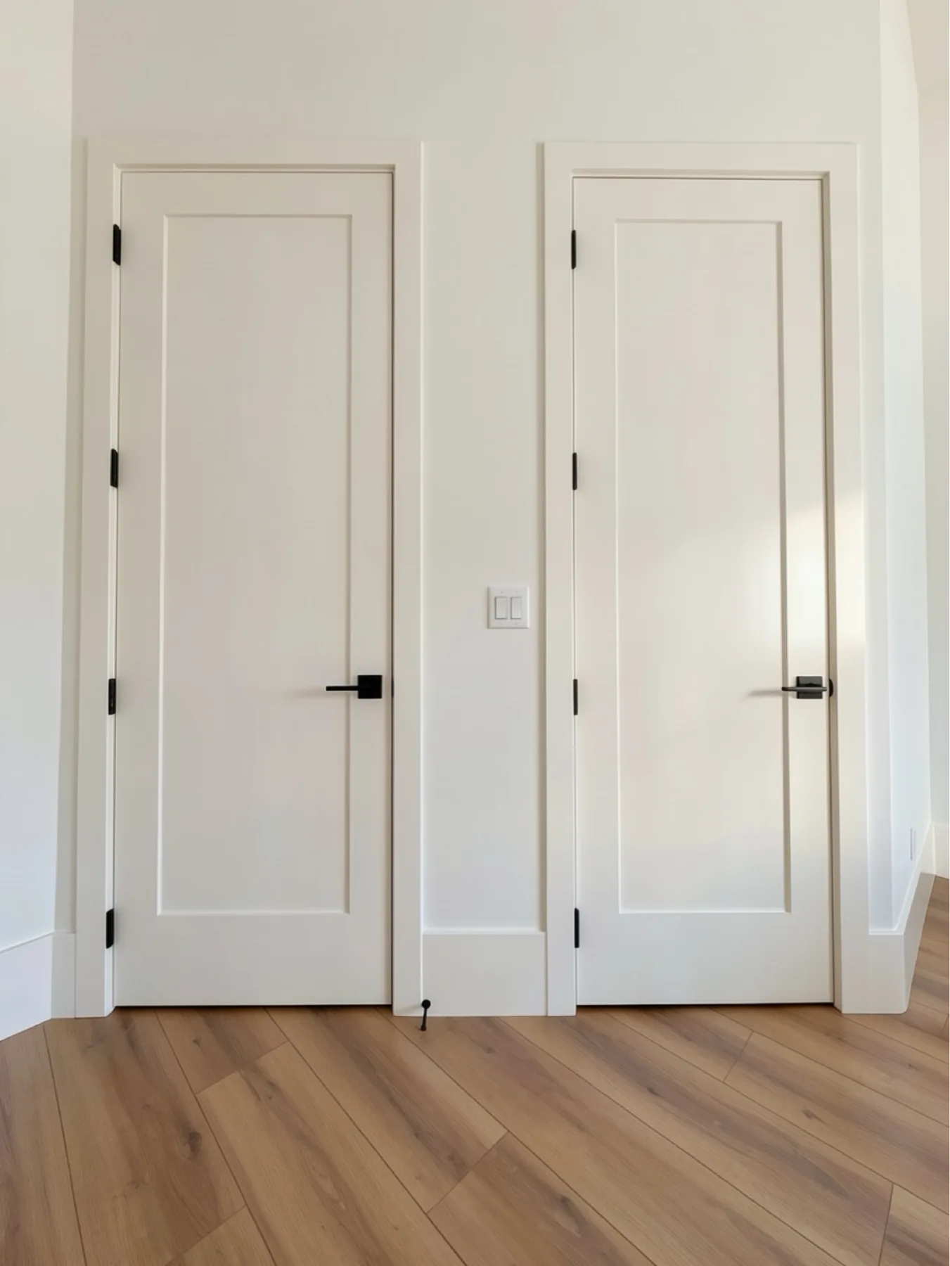 Double interior door installation with hardware and baseboard at The El Sendero Project
