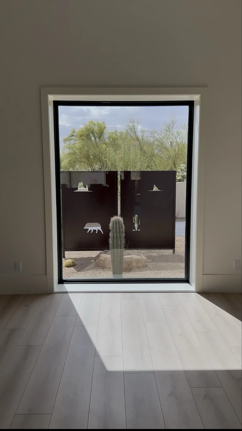 Window jamb and trim installation with desert view at The El Sendero Project
