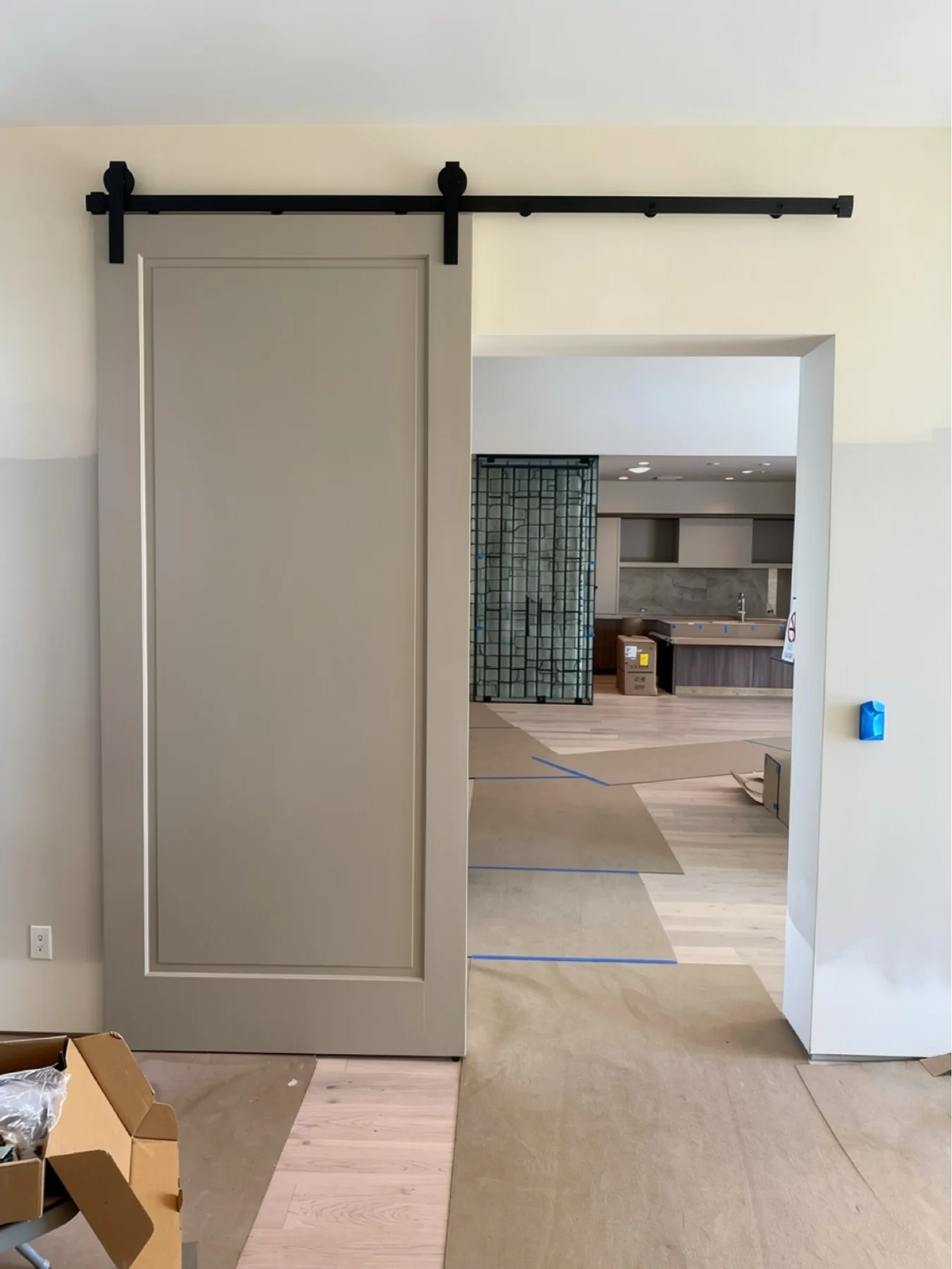 Barn door installation with black track hardware at The Phoenician Project