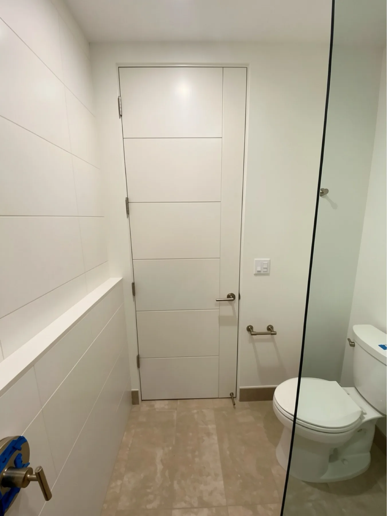 Finished bathroom door and hardware installation at The Phoenician Project