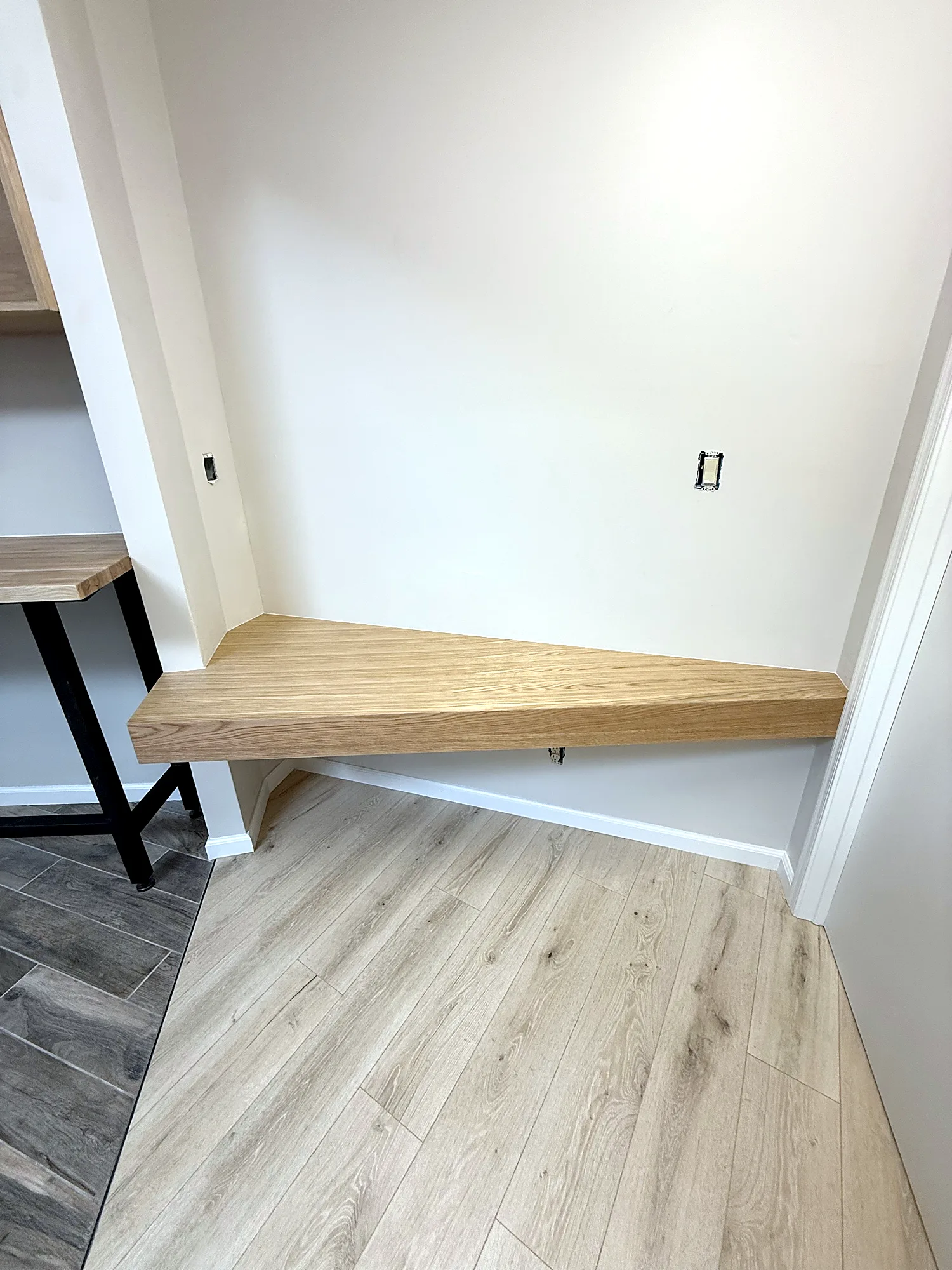 Floating desk wrapped in white oak plywood with mitered edges